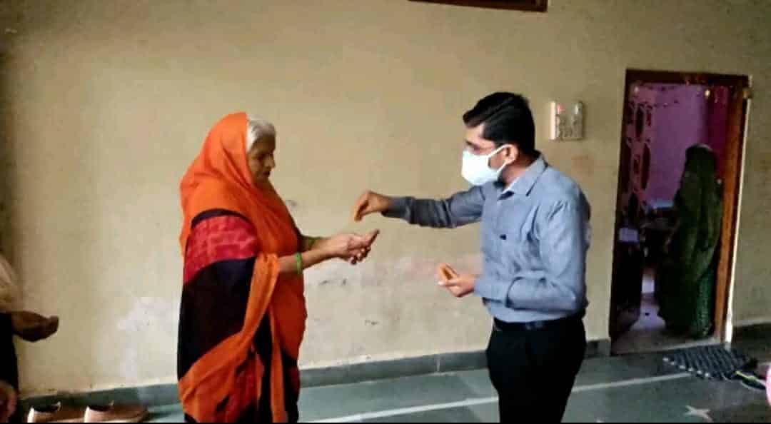 बाइक पर निकले SDM वैक्सीनेशन के लिए घर घर जाकर दे रहे पीले चावल