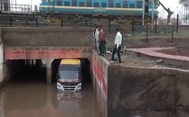 Bus-filled-with-passengers-trapped-under-railway-under-bridge