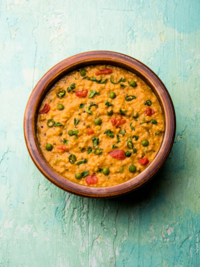 Vegetable masala oats khichadi served in a bowl. selective focus