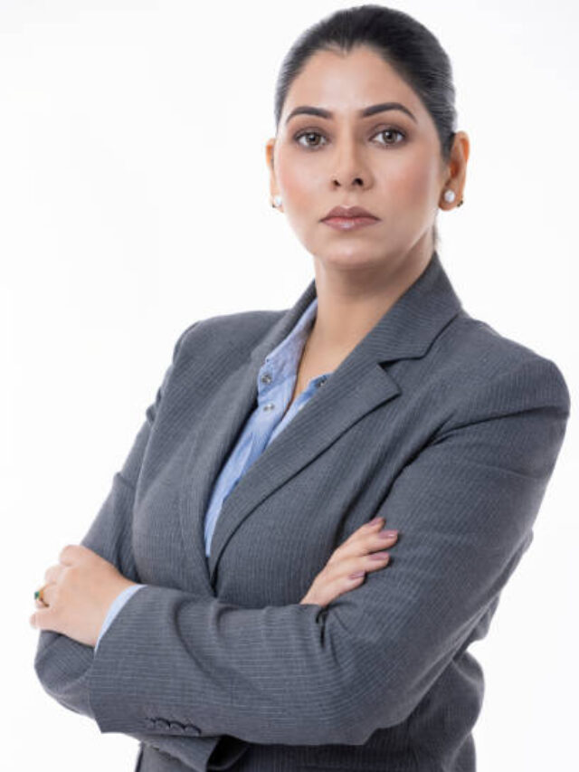 Businesswoman with arms crossed standing on white background