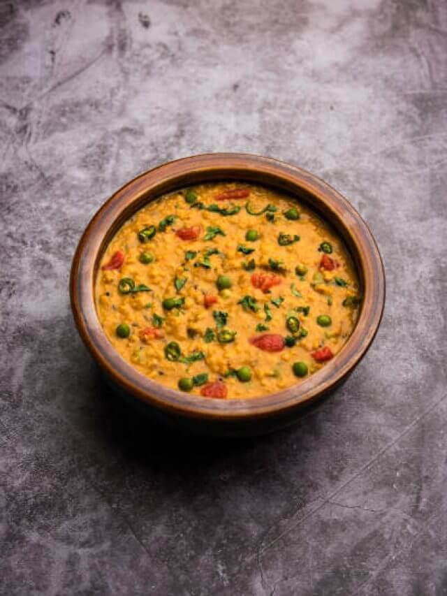 Vegetable masala oats khichadi served in a bowl. selective focus